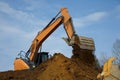 backhoe digging hydraulic shovel on construction site earth mover excavator dumping earth