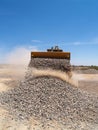 Backhoe Dumping Gravel