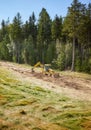 Backhoe levels hill surface for a ski slope Royalty Free Stock Photo