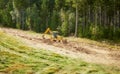 Backhoe levels hill surface for a ski slope Royalty Free Stock Photo
