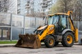 Widespread model of universal backhoe loader of JCB Company Great Britain of recognizable yellow colour.