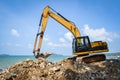 Backhoe Loader Digger Excavator Stone Working Construction Site On The Beach Sea Ocean