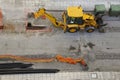 Backhoe loader digging in city street Royalty Free Stock Photo