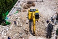 The backhoe machinery working on site demolition of an old building workers spray water to get rid of dust Royalty Free Stock Photo