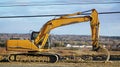 Backhoe on an open field to be developed