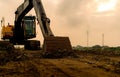 Backhoe parked at construction site after digging soil. Closeup bucket of bulldozer. Digger after work. Earth moving machine at Royalty Free Stock Photo