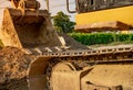 Backhoe parked at construction site after digging soil. Closeup bucket of bulldozer. Digger after work. Earth moving machine at Royalty Free Stock Photo