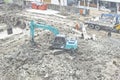 Backhoe penetrate the concrete construction.