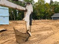 Backhoe scoop shovel attachment on dirt at a new home construction site