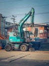 Backhoe to excavate the soil on ground in the construction area in Ramintra road near Synphaet Hospital