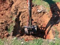 Backhoe to renovate the site in preparation for pouring the concrete slab