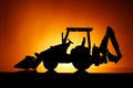 Backhoe tractor silhouette, orange background