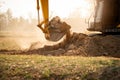 Backhoe working by digging soil at construction site. Crawler excavator digging on demolition site. Excavating machine. Earth