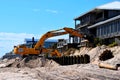 Backhoe working at fixing beach erosion.