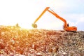 Backhoe working on garbage dump in landfill. People Working at Landfill site Royalty Free Stock Photo