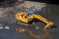 Backhoe working in a river