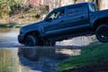 Backing a black pickup truck out of a flood