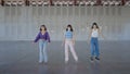 Backing shot following three young women roller skating, slomo