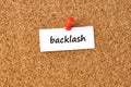 Backlash. Word written on a piece of paper, cork board background