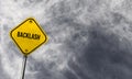 Backlash - yellow sign with cloudy background