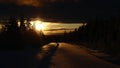 Backlight image of snow road with footsteps in Vasterbotten, Sweden Royalty Free Stock Photo