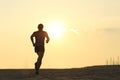 Backlight of a jogger running on the beach