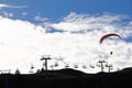 Backlight shot of a paraglider in front of a chairlift