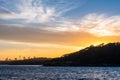 Backlight skyline of Sydney CBD from the bay at sunset Royalty Free Stock Photo