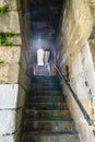 Backlight with sun reflections on ancient stone stairs under a tunnel in a narrow passageway next to the banks of the Douro river