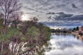 Backlight of a sunset over the river Ebro in the city of LogroÃÂ±o in Spain with the sky full of black clouds threatening rain, wit