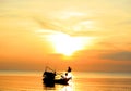 Backlit boat in the dawning ocean