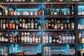 Backlit bottles and glassware behind a bar also known as the back bar. Minsk, Belarus - August 1, 2020