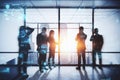 Backlit business people working tohether in abstract creative blurry office interior with business charts and binary code. System Royalty Free Stock Photo