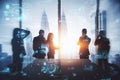 Backlit businessmen and women working tohether in abstract creative blurry office interior with business charts and binary code. Royalty Free Stock Photo