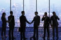 Backlit businesspeople standing in panoramic office interior with city view. Teamwork concept Royalty Free Stock Photo