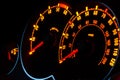 Backlit car dashboard dials glowing at night Royalty Free Stock Photo