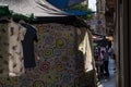 Backlit clothing and sheets in a popular market where the seller