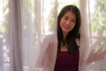 Backlit dreamy portrait of young happy and beautiful Asian Korean woman at luxury hotel room balcony relaxed and indulged enjoying Royalty Free Stock Photo