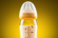 Backlit glass baby bottle with powdered milk closeup on upper part