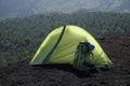 Backlit green tent and backpack in Etna Park