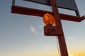 Backlit highway construction warning light at sunset Royalty Free Stock Photo