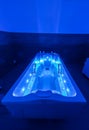 Backlit hot tub for relaxation and rehabilitation spa treatments in a medical clinic Royalty Free Stock Photo