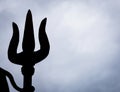 backlit isolated shot of hindu god shiva trident with dramatic background