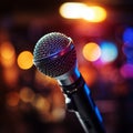 Backlit microphone close up with out of focus stage lights, musical ambiance captured