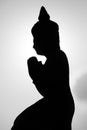 Backlit of monk sculpture meditating and praying with sky, Cambodia Royalty Free Stock Photo
