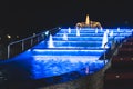 Backlit night fountain in a big city Royalty Free Stock Photo