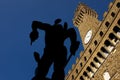 Backlit of Perseus bronzes with Palazzo Vecchio in the background Royalty Free Stock Photo