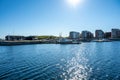 Backlit photo of a new seaside neighborhood in Malmo, Sweden. Blue sky and and a calm blue ocean