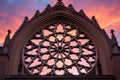 a backlit shot of a gothic revival rose window during sunset