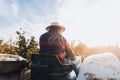 Backlit shot of a latin farmer woman driving an old tractor, in the middle of his farmland at sunset Royalty Free Stock Photo